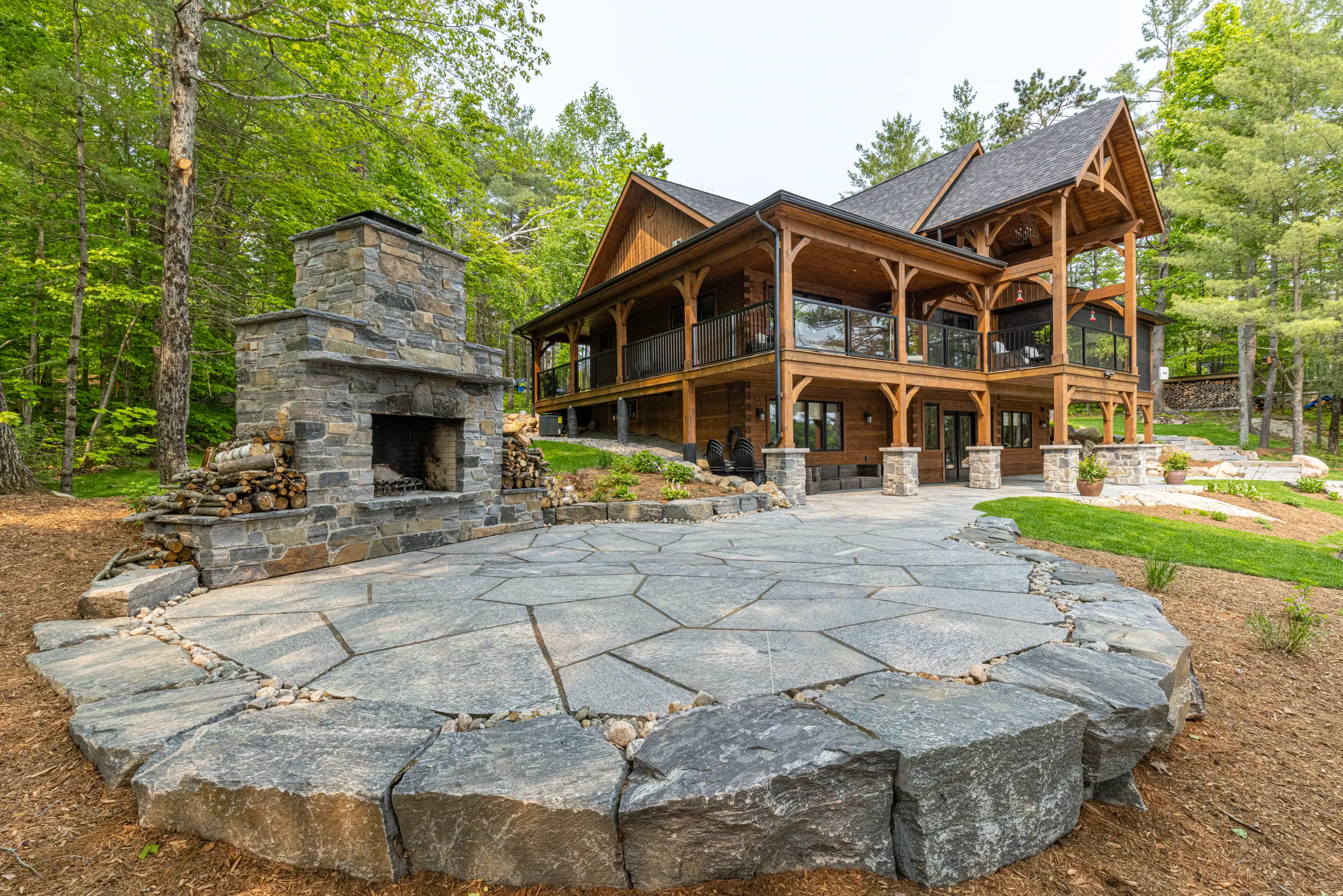 Natural stone terrace and fireplace at a NuScape waterfront property
